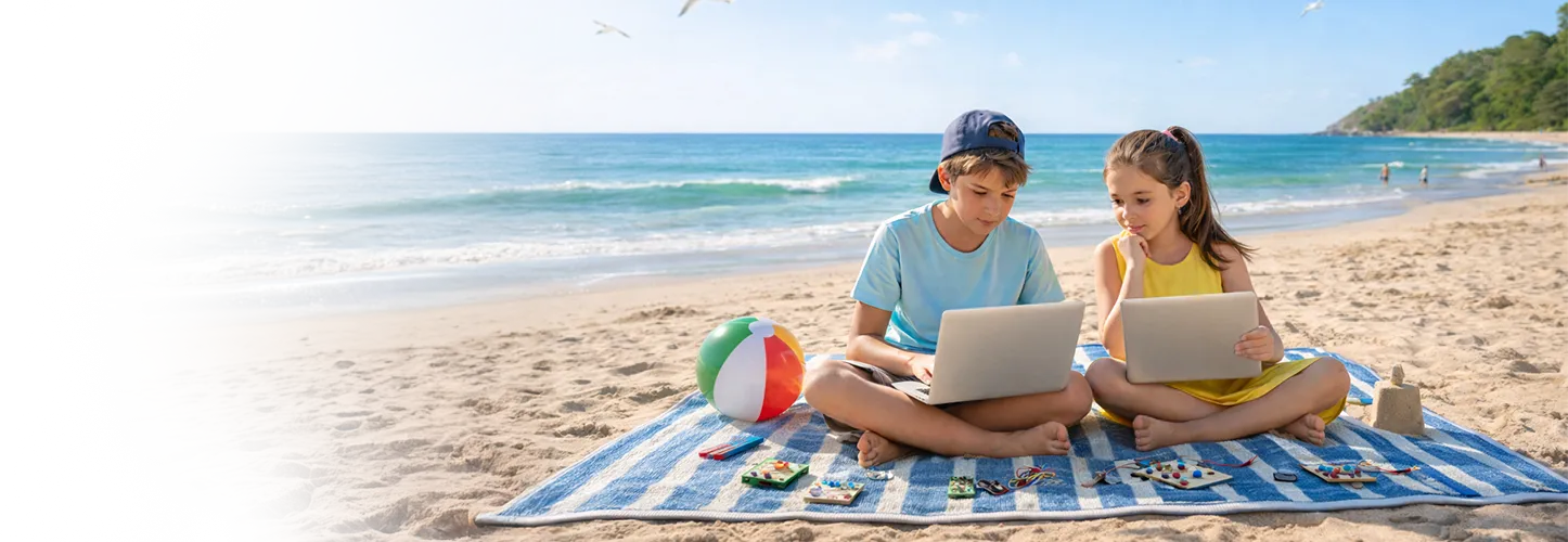 Kids coding on laptops at the beach
